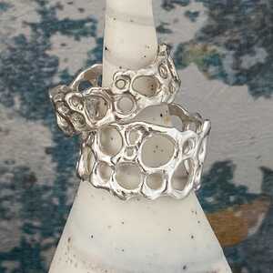 This is a picture of an organic design silver and blue stone ring