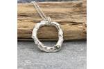 Organic silver circle pendant with a green sapphire 3