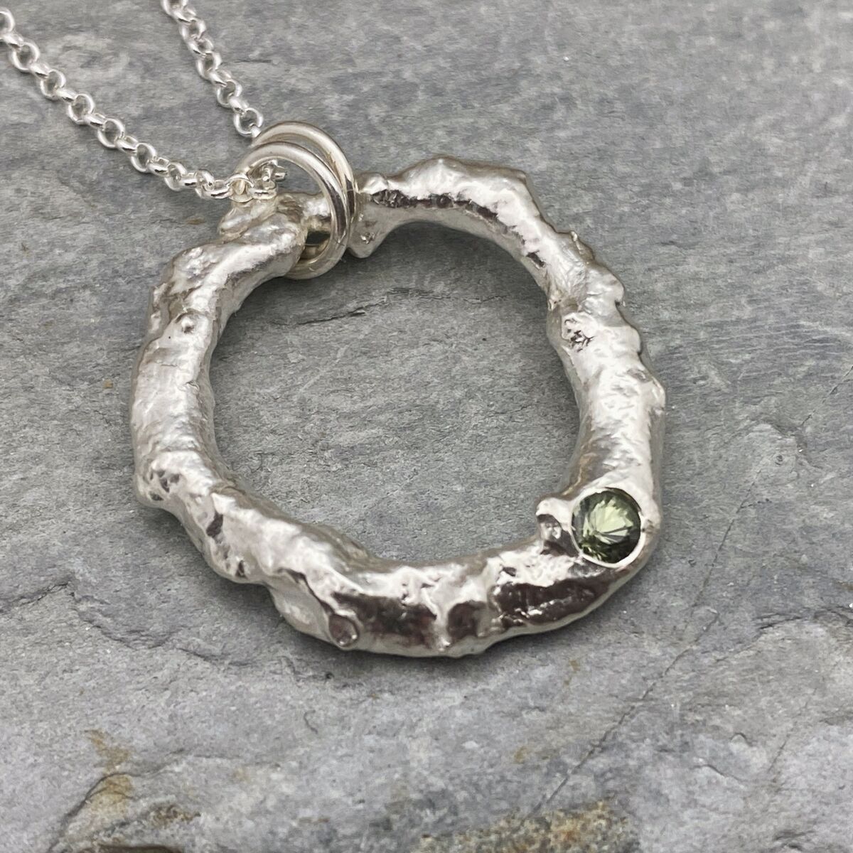 Organic silver circle pendant with a green sapphire 4 Organic silver circle pendant with a green sapphire 4