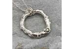 Organic silver circle pendant with a green sapphire 4