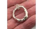 Organic silver circle pendant with a green sapphire 2