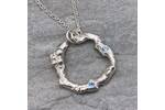 Organic silver circle pendant with two blue Topaz stones. 2