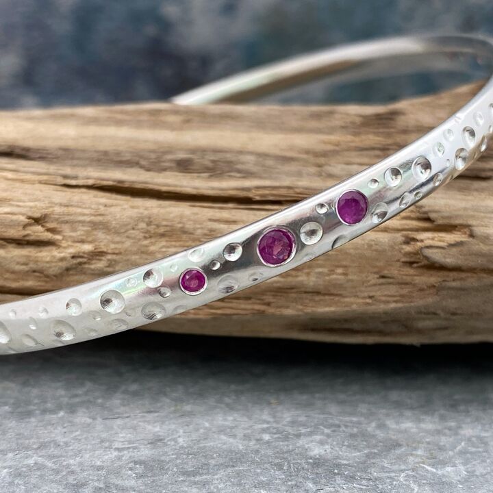 Solid silver and pink sapphire bangle