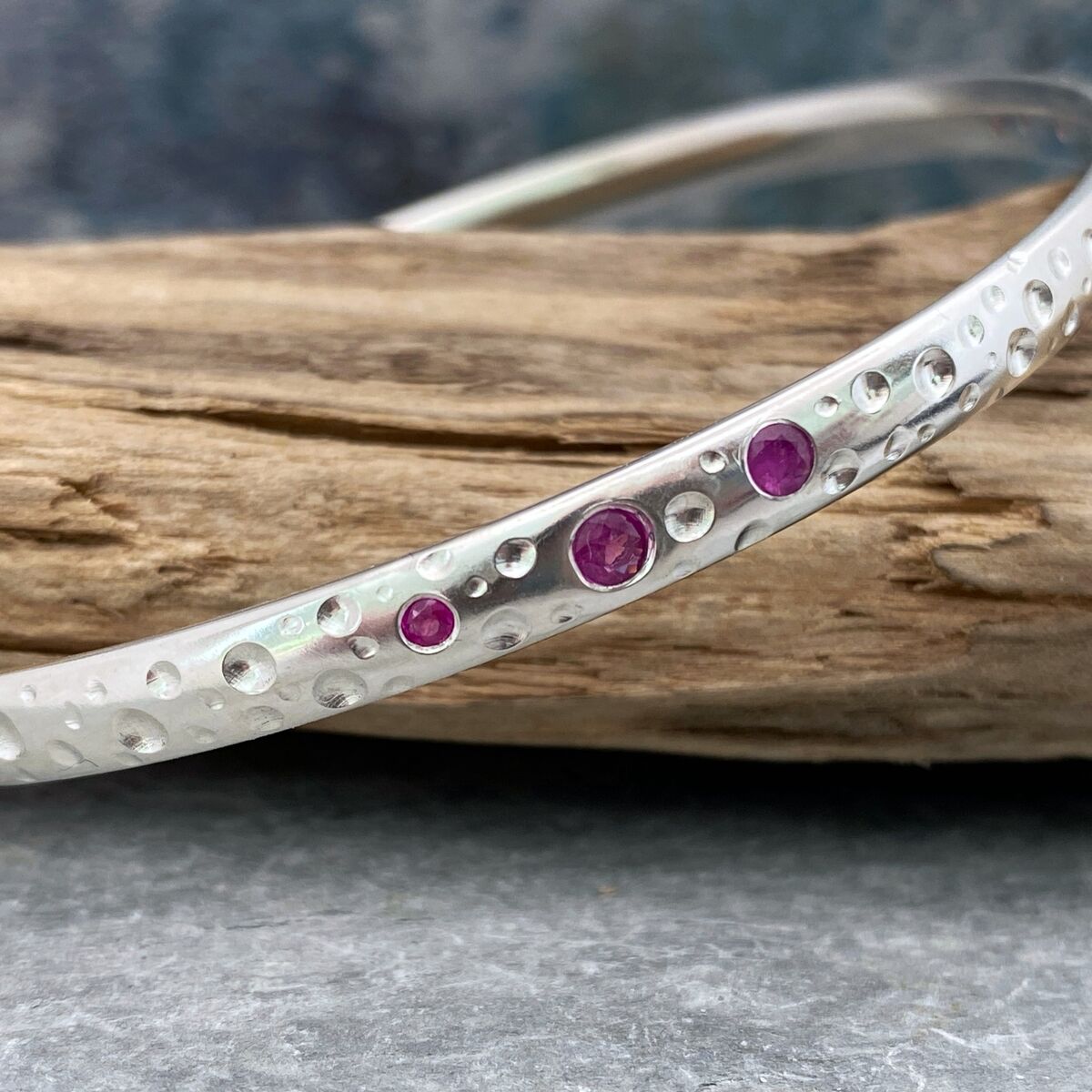 Solid silver and pink sapphire bangle