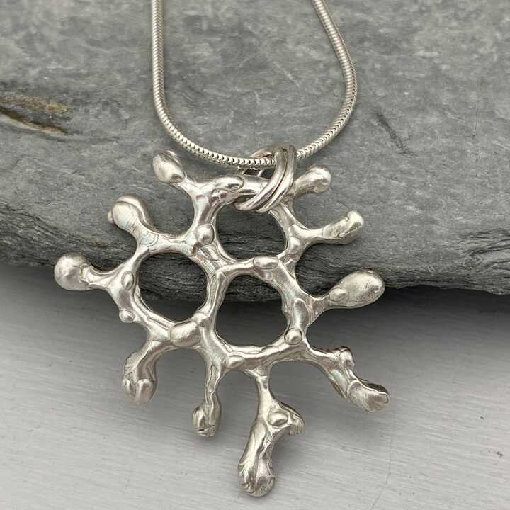 This is a picture of an organic undersea inspired silver pendant