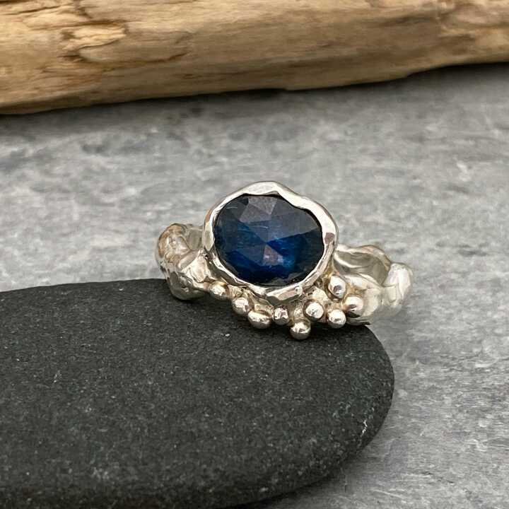 This is a picture of an organic design silver and blue stone ring