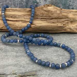 This is a picture of a blue and silver beaded necklace